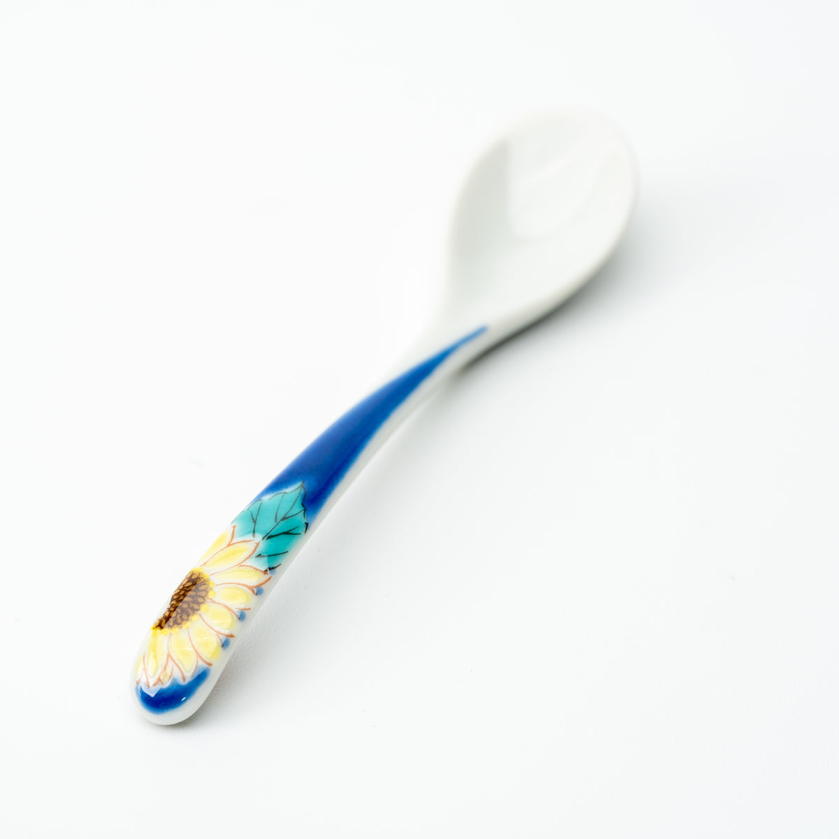 Kutani tea spoon with a yellow sunflower on a blue handle.