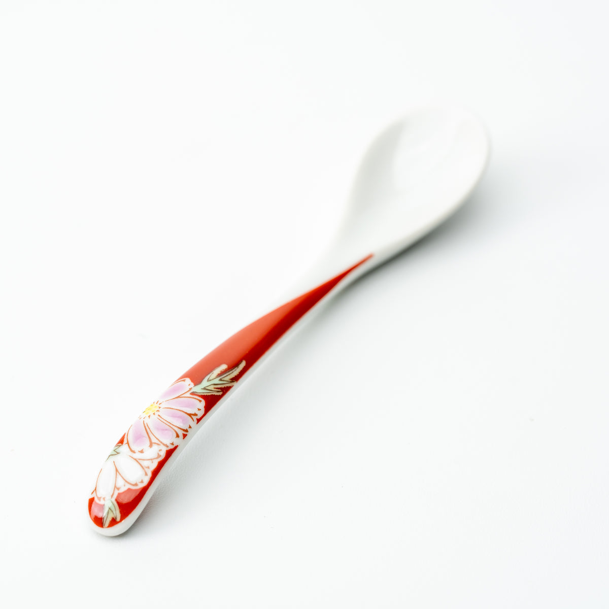 Kutani tea spoon with a pale pink flower on a red handle.