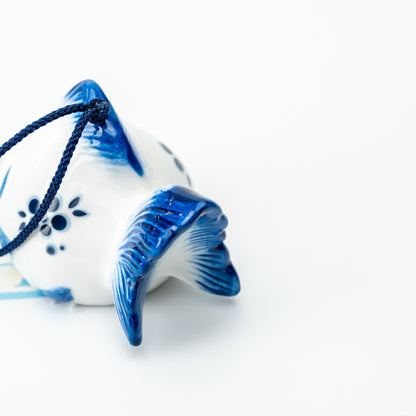 Rear detail of the goldfish wind chime, showing its flared blue tail and dark blue hanging cord.