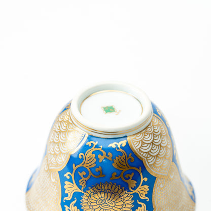 Underside of the blue-and-gold chrysanthemum cup, showing a green maker's mark within the foot ring.