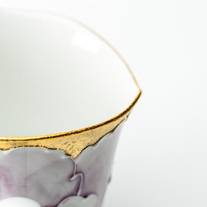 Detail of the purple Bunzan peony mug's scalloped gold-colored rim and white interior.
