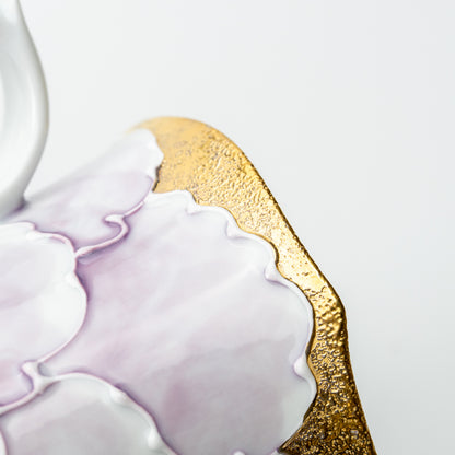 Close-up of a raised pale purple peony beside textured gold-colored decoration on the Bunzan mug.