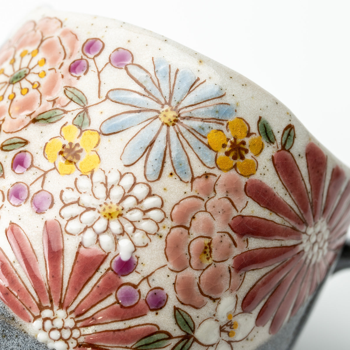 Close-up of the Hana mug's red and pink flowers with smaller blue, yellow and purple blossoms.
