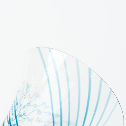 Detail of the flared rim and fine blue lines of the clear Yachiyo sake cup.