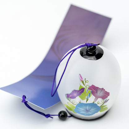 White morning glory wind chime with a purple cord and matching paper tag, shown upright.