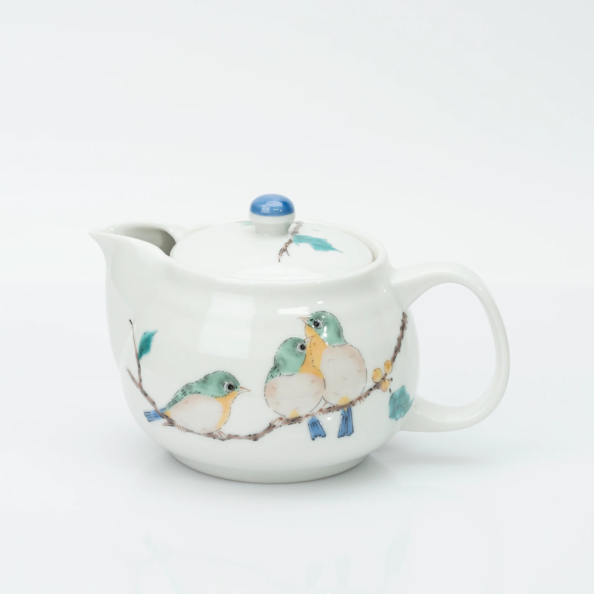 Kutani porcelain teapot in white, three mejiro birds perched on a berry branch in green, yellow and blue, blue bud finial on the lid.