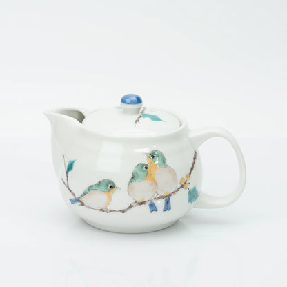 Kutani porcelain teapot in white, three mejiro birds perched on a berry branch in green, yellow and blue, blue bud finial on the lid.