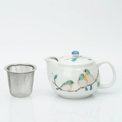 Japanese kyusu teapot beside its removable stainless steel mesh strainer, the two pieces that make up the set.