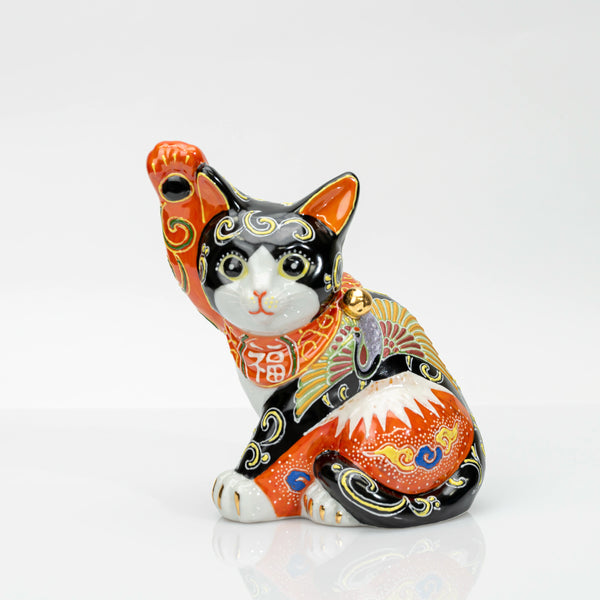 Kutani porcelain maneki neko with Red Fuji and crane, right paw raised, front view