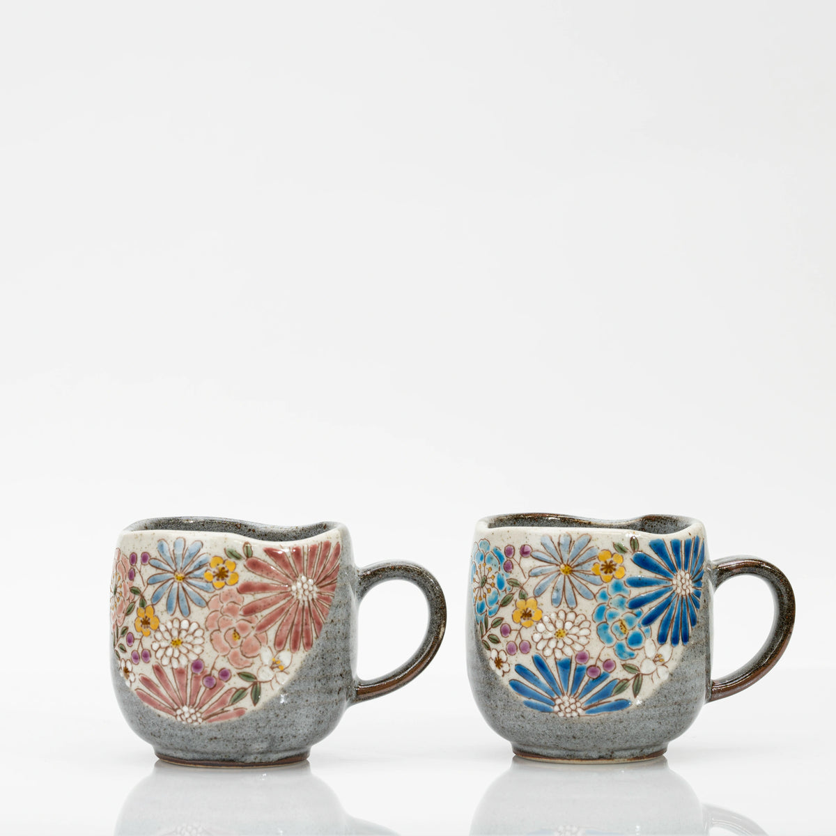 Pair of Kutani ceramic mugs, one with red and pink flowers and one with blue flowers