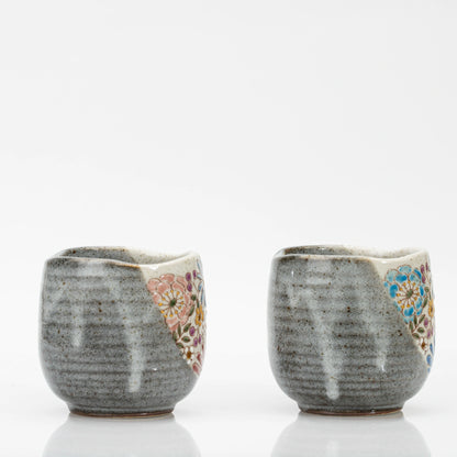 Two Kutani mugs seen from behind, showing the speckled grey glaze with pale vertical streaks