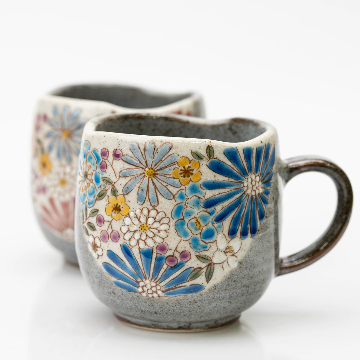 Close-up of the blue Kutani mug's blue starburst blooms and wavy rim
