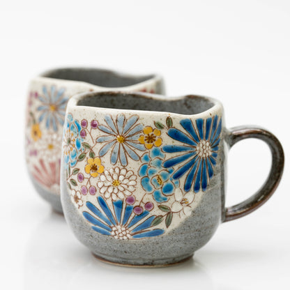 Close-up of the blue Kutani mug's blue starburst blooms and wavy rim