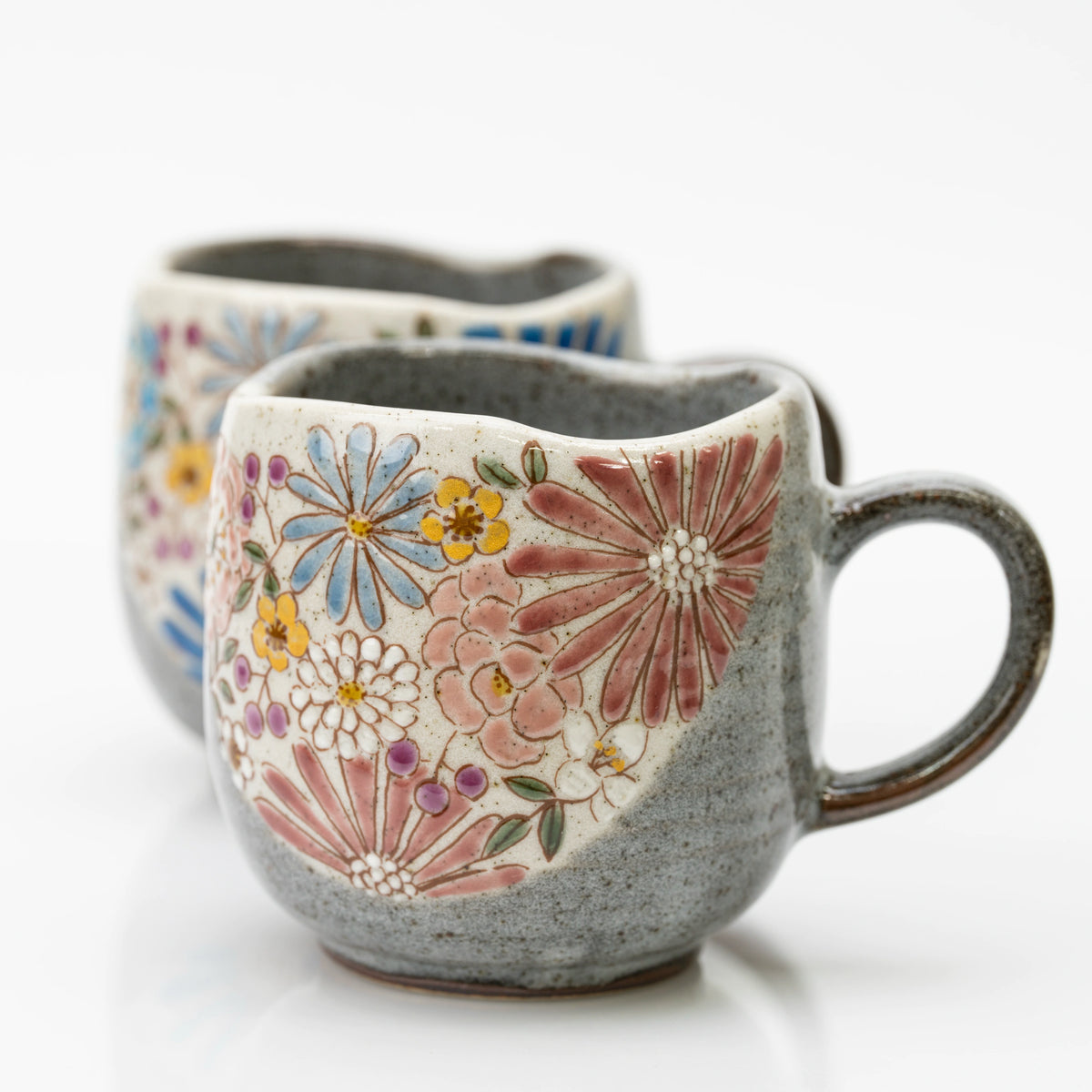 Close-up of the red Kutani mug's large pink and red blooms and wavy rim