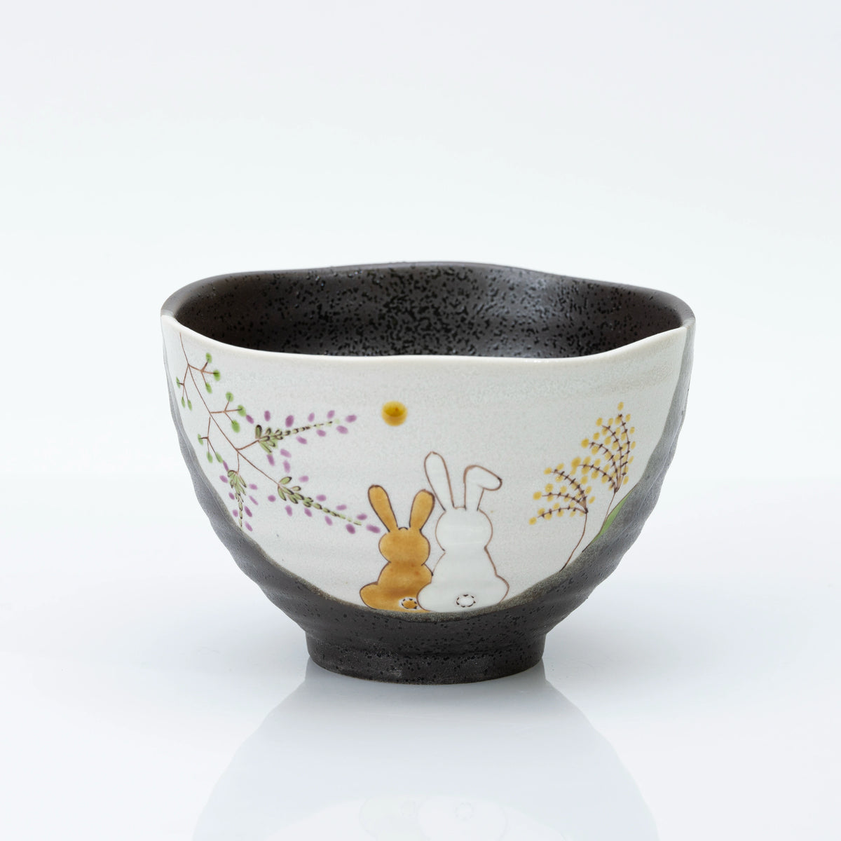 Kutani rice bowl with two rabbits and flowers painted on a cream panel
