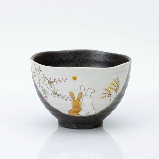Kutani rice bowl with two rabbits and flowers painted on a cream panel