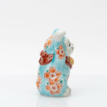 Opposite side of blue lucky cat showing blossoms along the body and raised paw