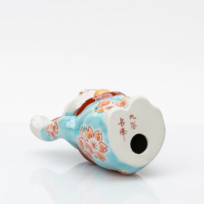 Underside of Kutani lucky cat showing the red Chōhō mark and vent hole