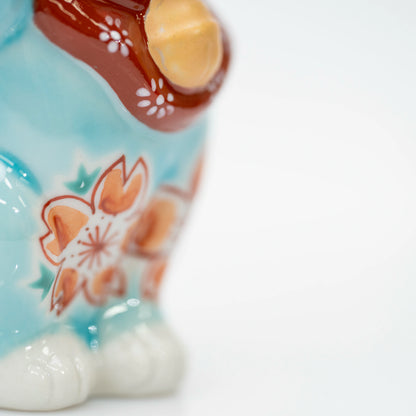 Close-up of cherry blossoms along the side of the turquoise blue cat