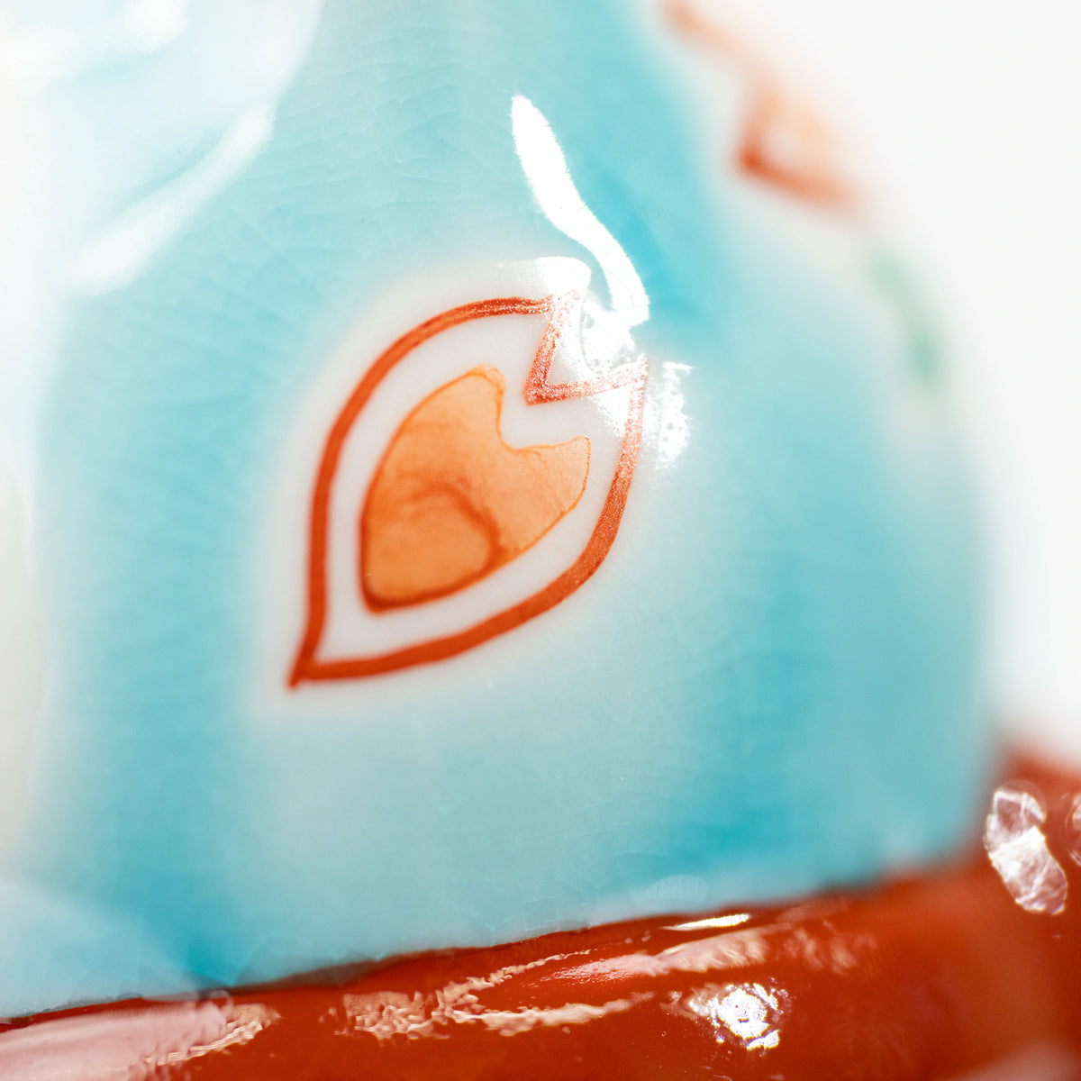 Close-up of a small blossom and fine crackle pattern in the turquoise blue glaze