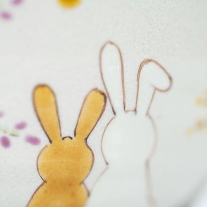 Close-up of the amber and white rabbits painted by hand