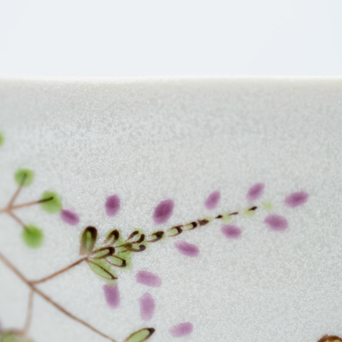 Close-up of a purple flowering branch beside the rabbits