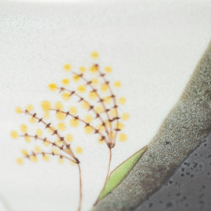 Close-up of a yellow flower on a painted branch