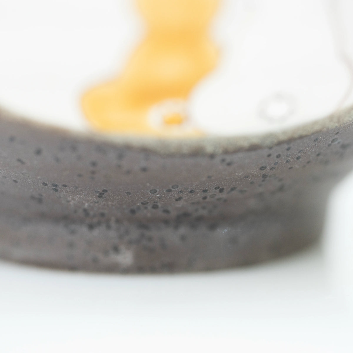 Close-up of the dark speckled glaze on the bowl