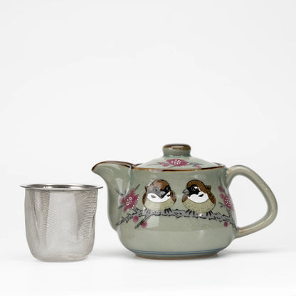 Sparrow teapot, teapot with the removable mesh strainer beside it.