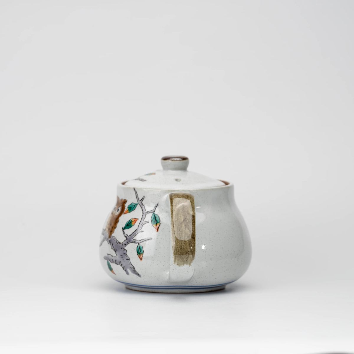 Owl teapot, side view showing the shape and surface.