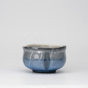 Blue ginsai matcha bowl, whole view on a neutral background.