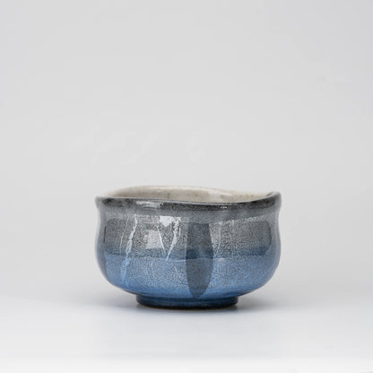 Blue ginsai matcha bowl, whole view on a neutral background.