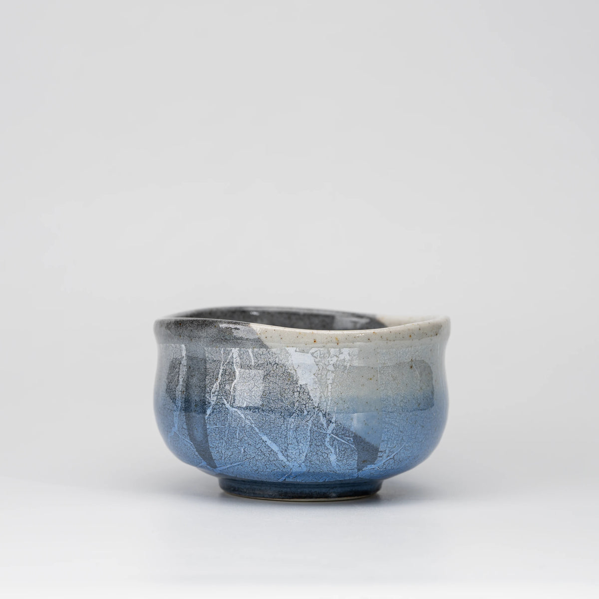 Blue ginsai matcha bowl, side view showing the shape and surface.