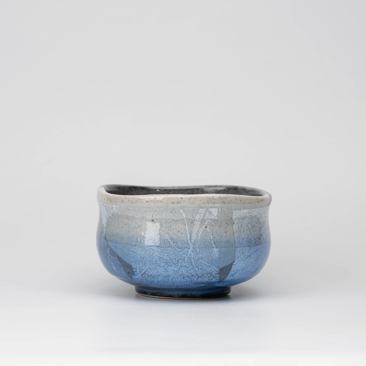 Blue ginsai matcha bowl, side view showing the shape and surface.