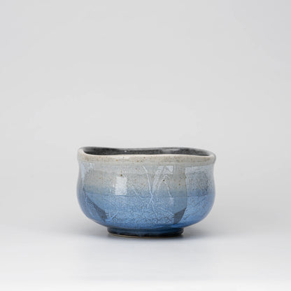 Blue ginsai matcha bowl, side view showing the shape and surface.