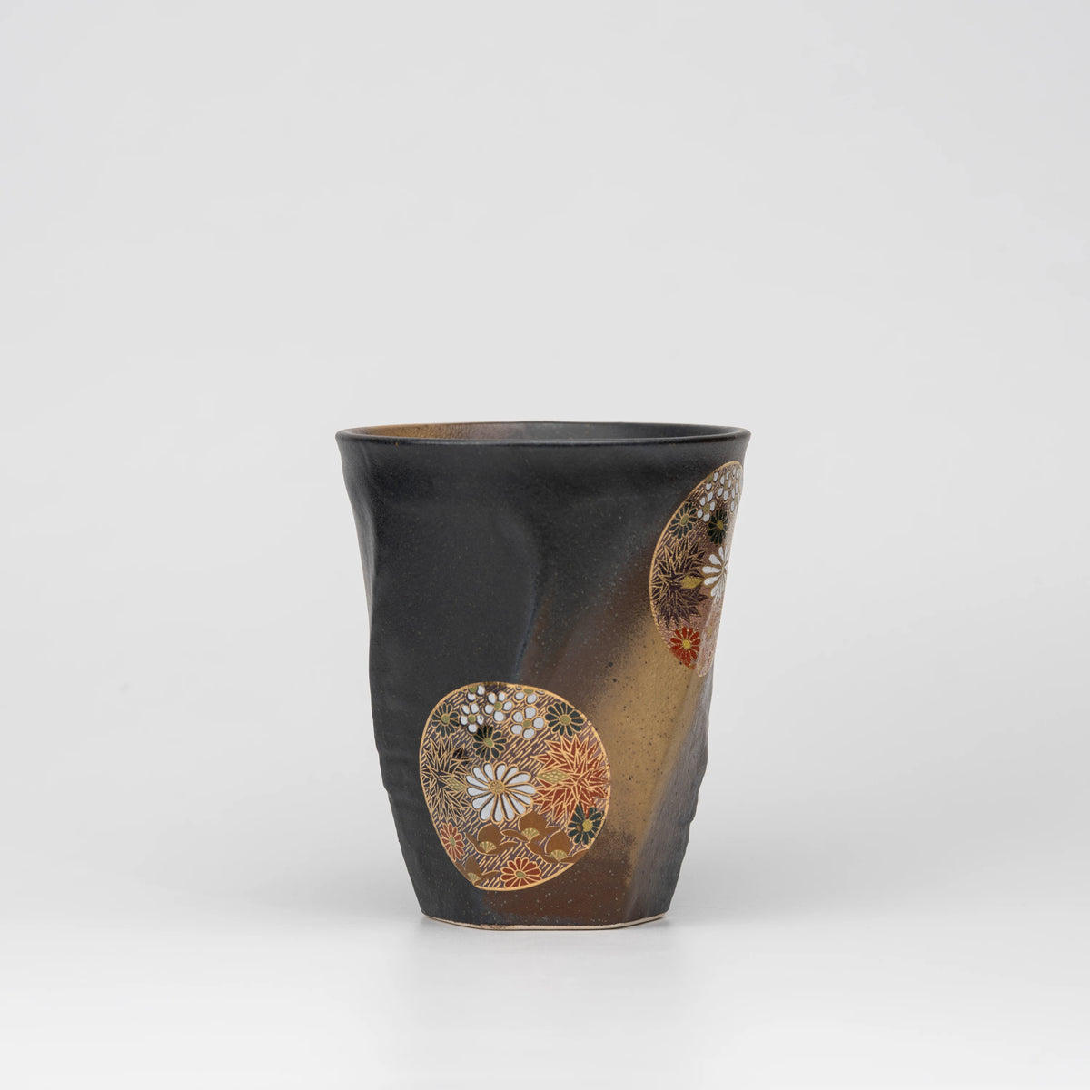 Dark floral medallion cup, side view showing the shape and surface.
