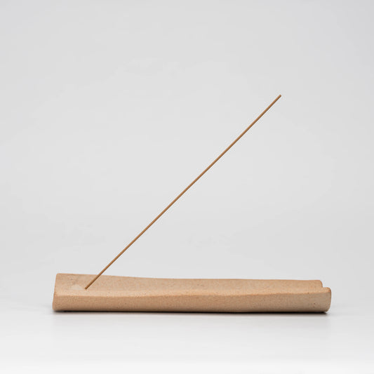 Brown floral incense holder, whole view on a neutral background.