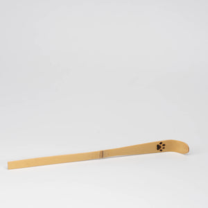 Paw-print bamboo matcha scoop, whole view on a neutral background.