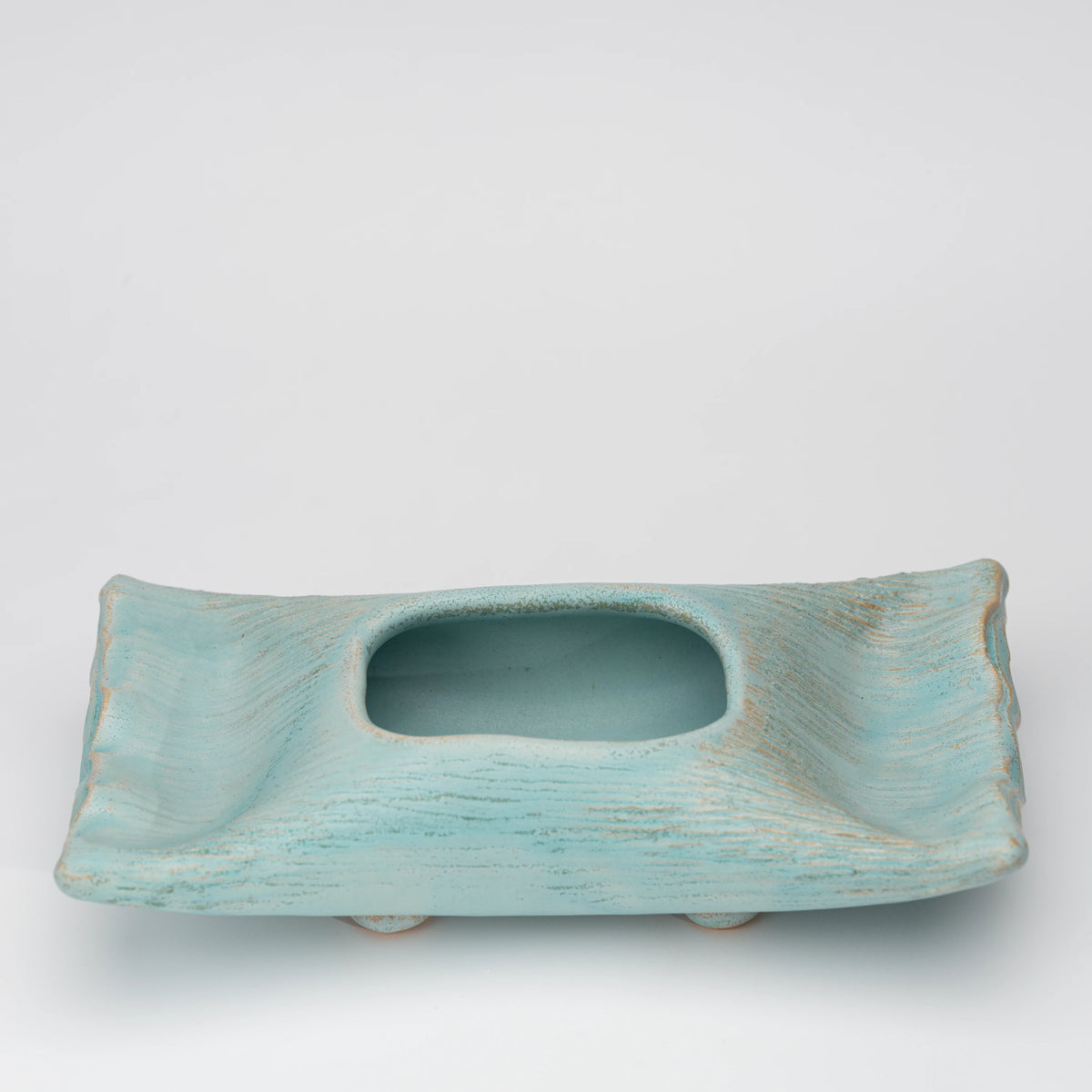 Pale blue mini ikebana vase, side view showing the shape and surface.