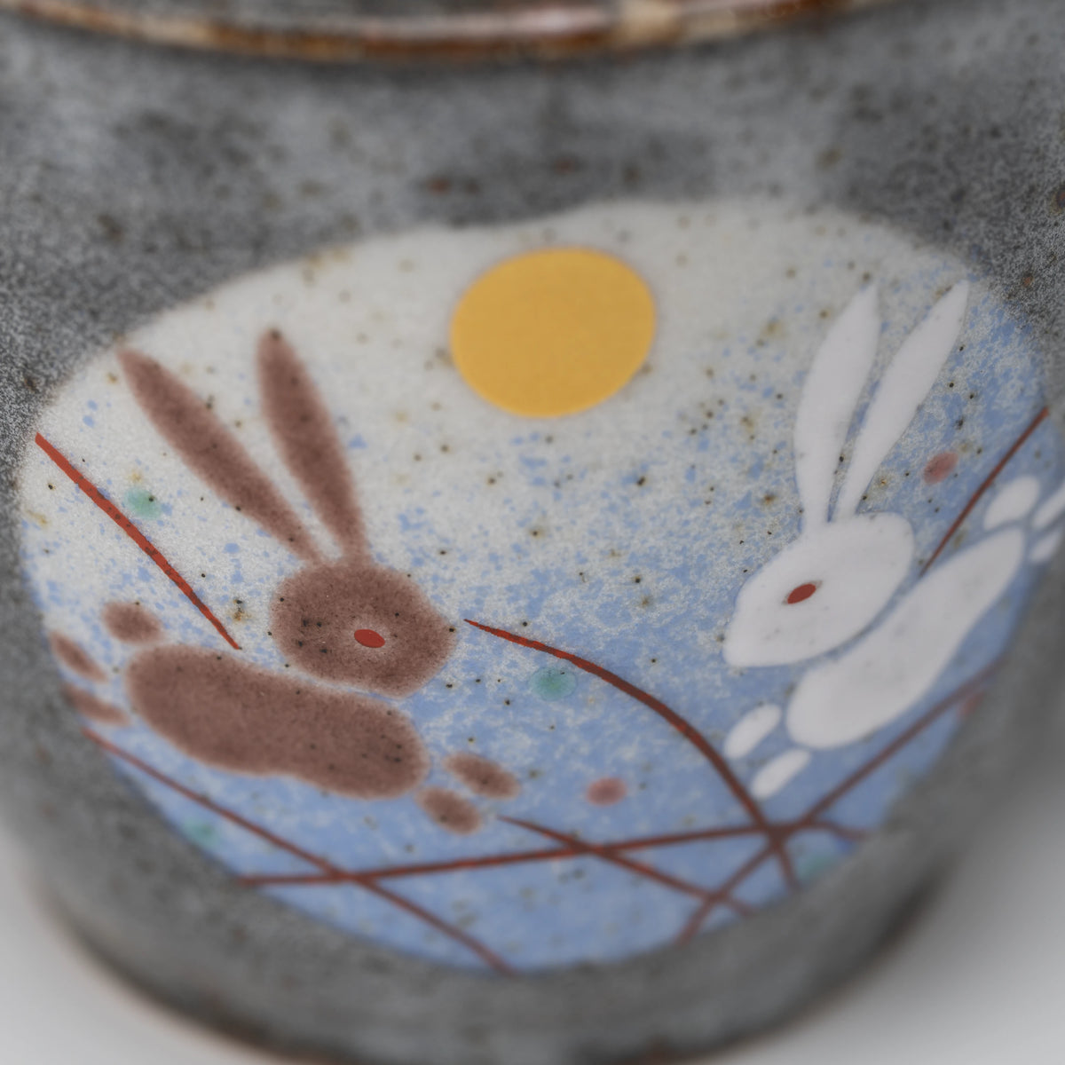 Rabbit motif mug, side view showing the shape and surface.