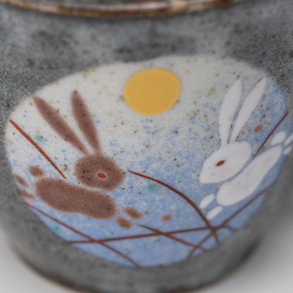 Rabbit motif mug, side view showing the shape and surface.