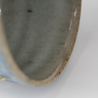 Ribbed blue-grey tea cup, rim and interior detail.