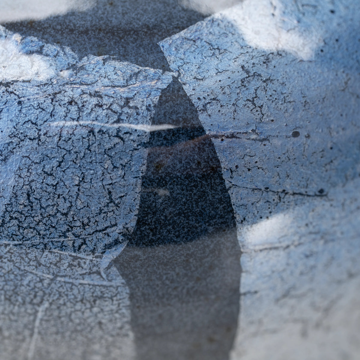 Blue ginsai matcha bowl, foil panel and glazed surface detail.