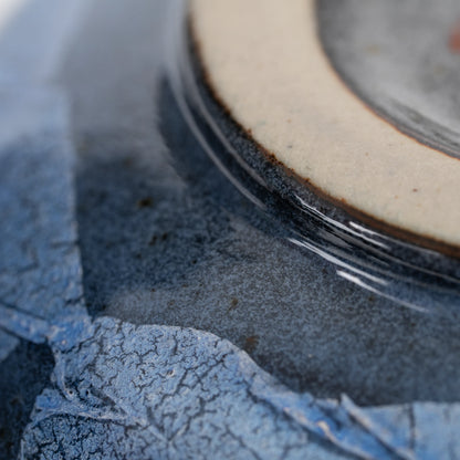 Blue ginsai matcha bowl, foil panel and glazed surface detail.