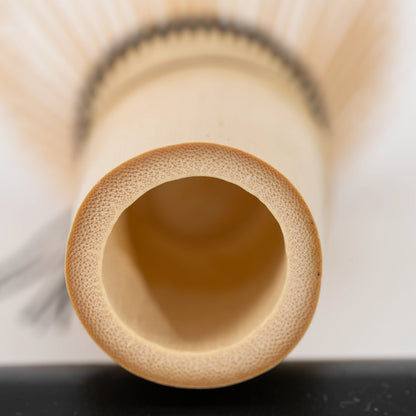 Paw-print bamboo mini whisk, hollow bamboo handle viewed from below.