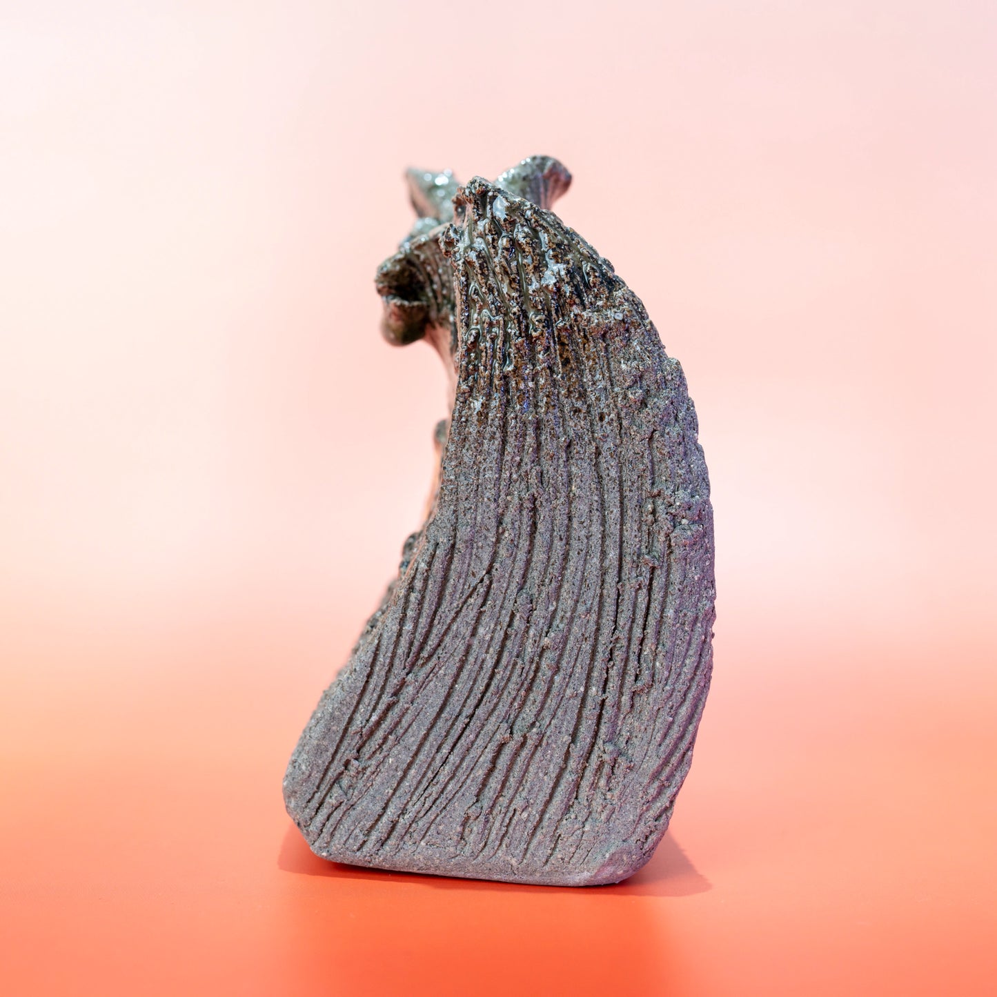 Side profile of a Shigaraki ware bud vase with an organic curved silhouette