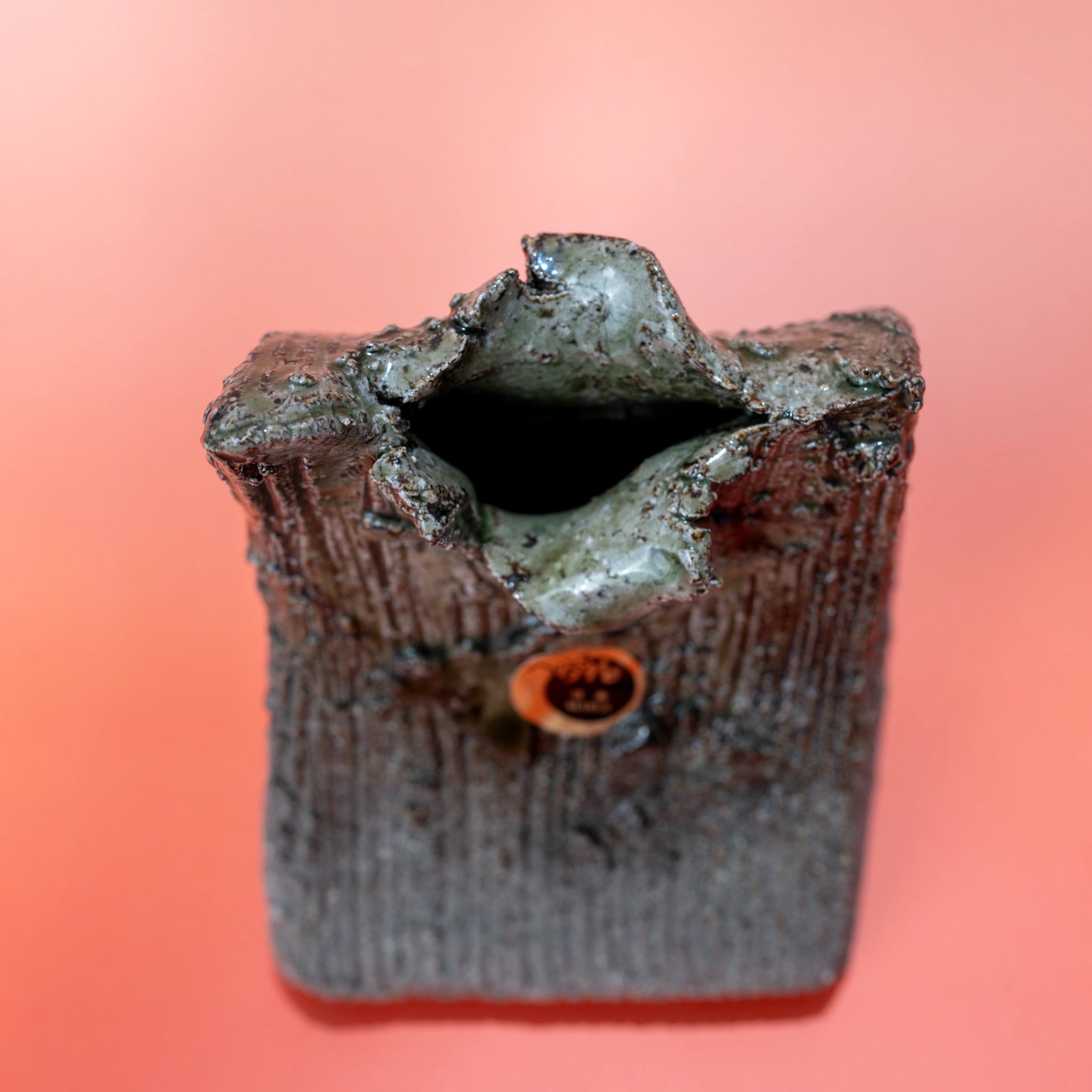 Top-front view of a Shigaraki ware bud vase showing the opening and textured body