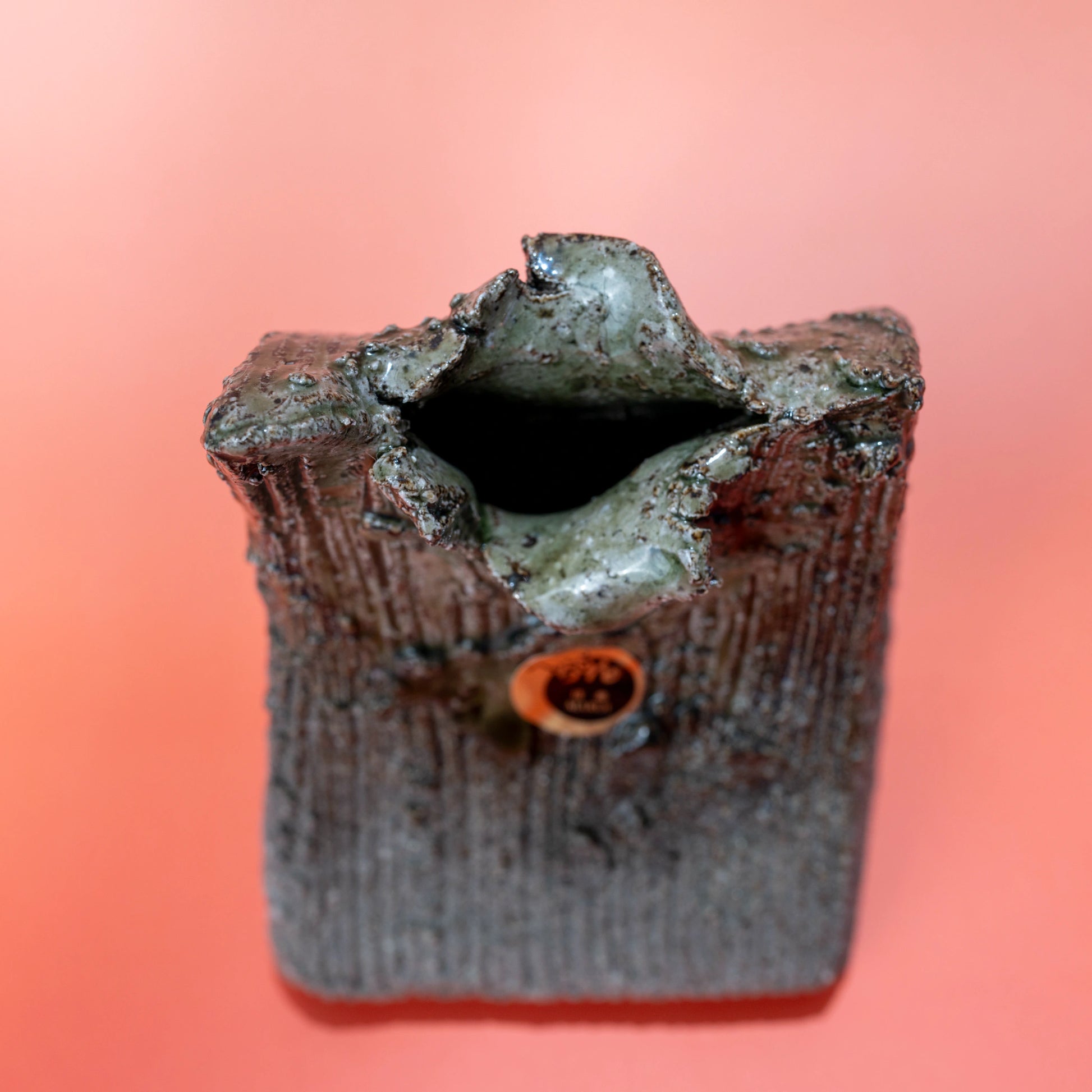 Top-front view of a Shigaraki ware bud vase showing the opening and textured body