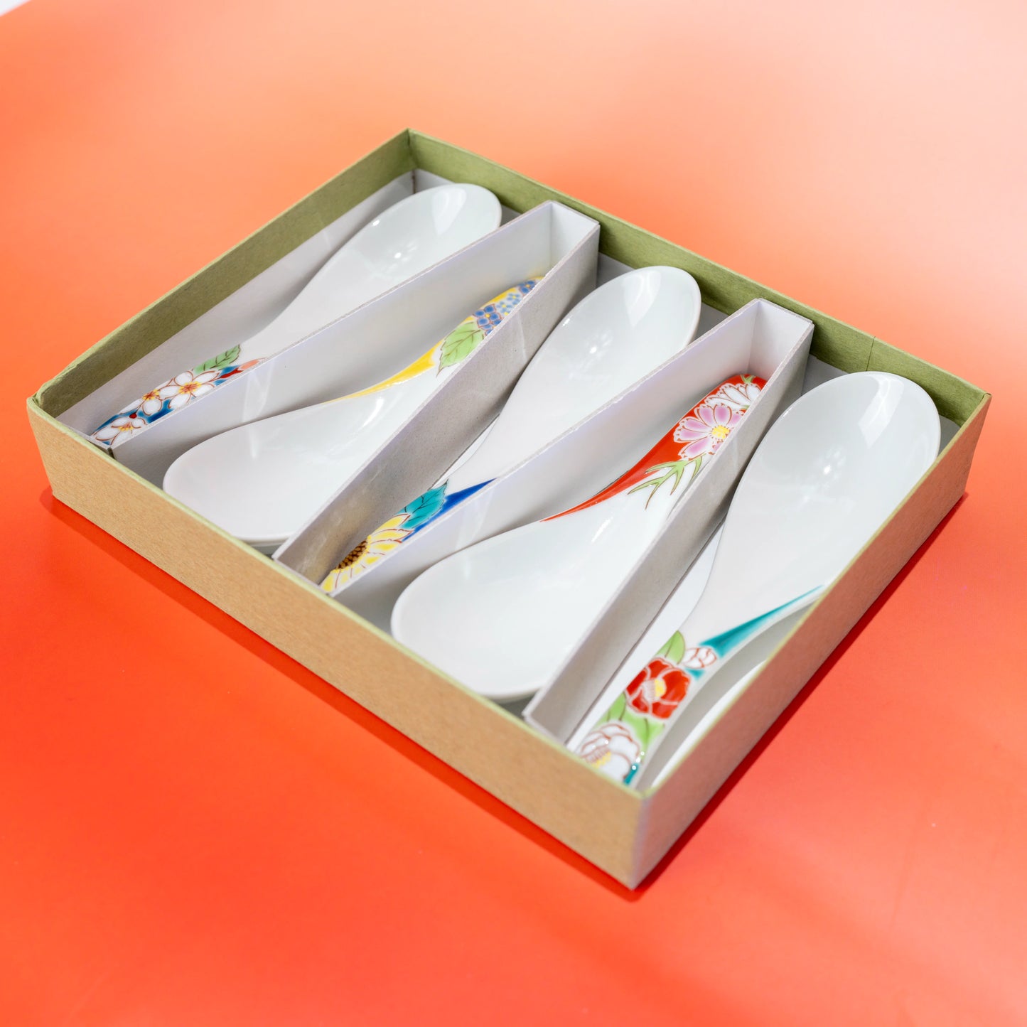 Angled open-box view of the Kutani floral porcelain spoon set