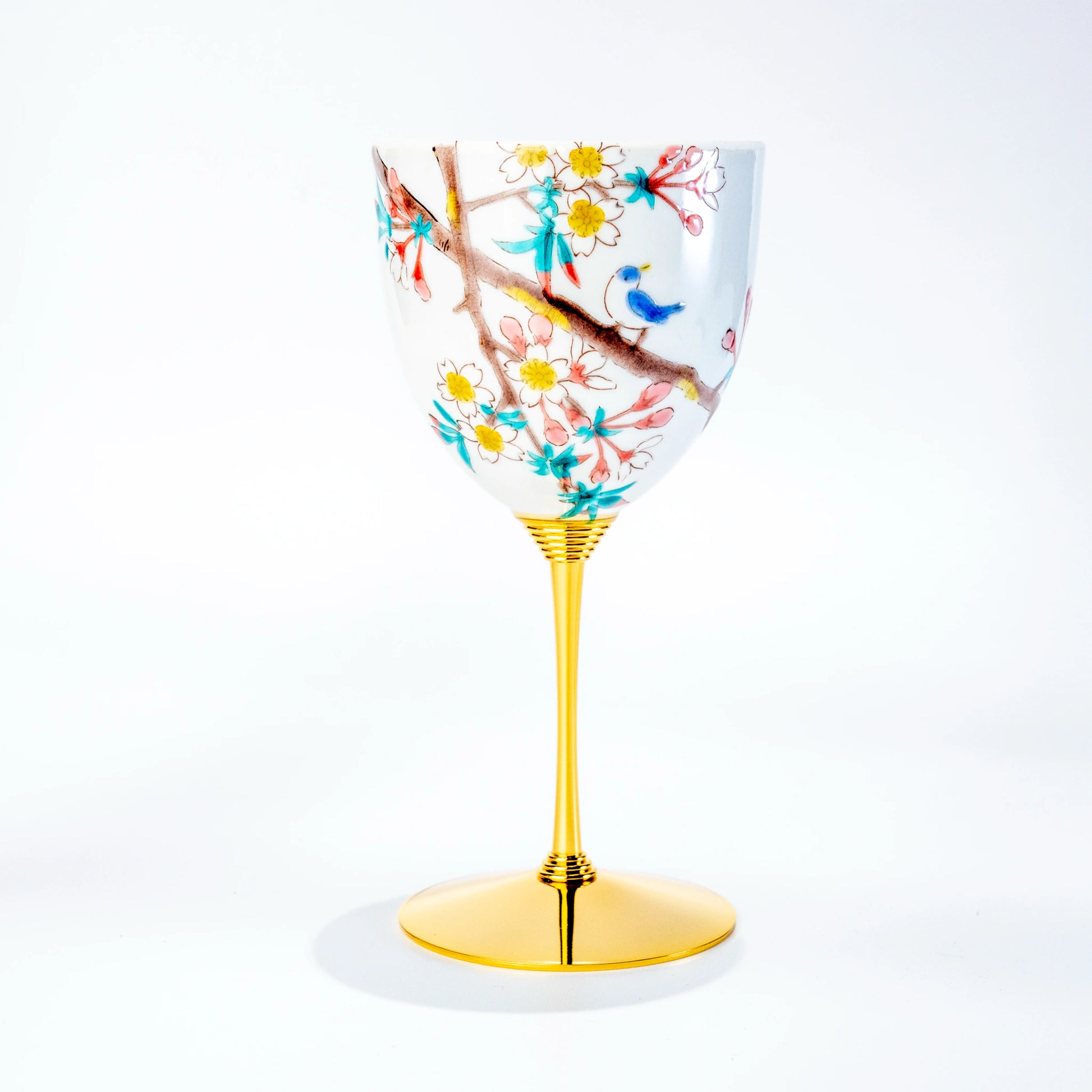 Single Kutani wine cup with bird and flowering branch motif on a gold stem